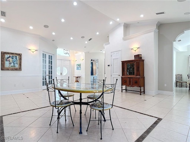 dining space featuring crown molding, light tile patterned floors, and high vaulted ceiling