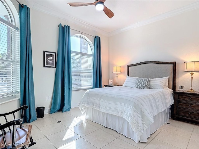 tiled bedroom featuring ornamental molding and ceiling fan