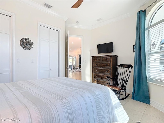 tiled bedroom featuring ornamental molding, a closet, and ceiling fan