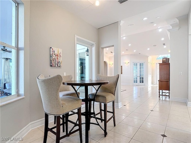 dining room with vaulted ceiling and light tile patterned floors