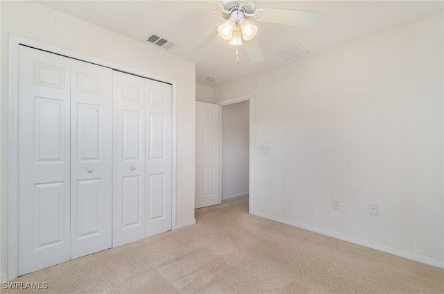 unfurnished bedroom with ceiling fan, a closet, and light colored carpet