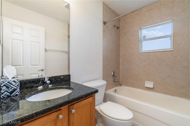 full bathroom featuring vanity, toilet, and tiled shower / bath combo