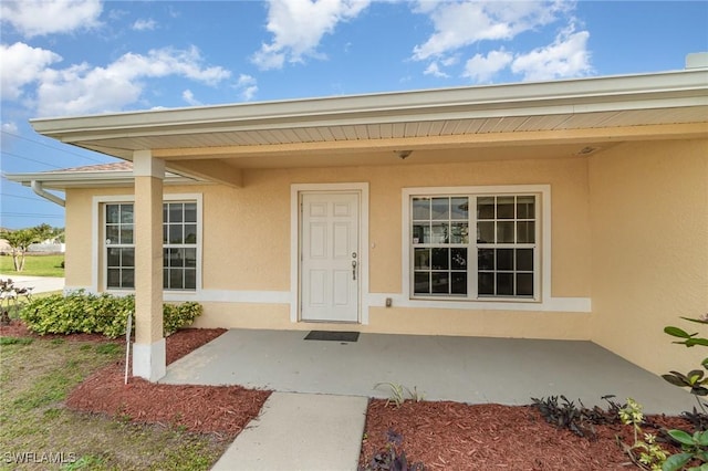 property entrance with a patio