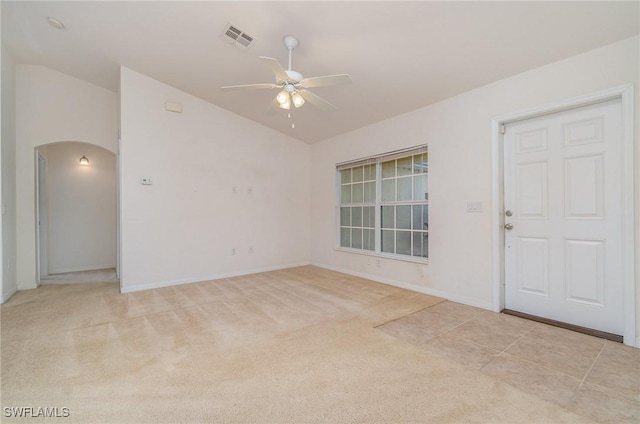 empty room featuring ceiling fan and light colored carpet