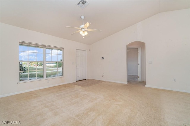 carpeted spare room featuring ceiling fan and lofted ceiling