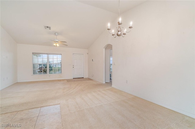 carpeted empty room featuring ceiling fan with notable chandelier and lofted ceiling