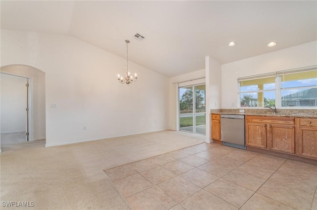 kitchen featuring dishwasher, a chandelier, light colored carpet, decorative light fixtures, and vaulted ceiling