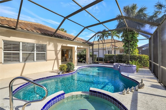 view of swimming pool featuring an in ground hot tub, a lanai, and a patio