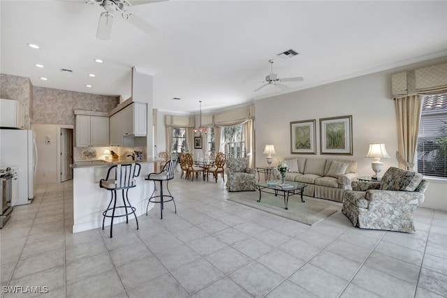 tiled living room with ceiling fan and crown molding