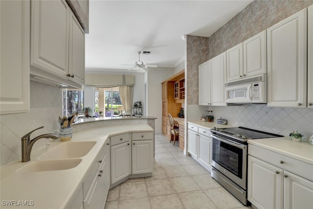 kitchen featuring white cabinetry, sink, kitchen peninsula, stainless steel electric range oven, and ceiling fan