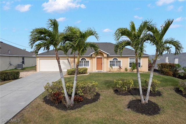 ranch-style house with a garage, a front yard, and central AC