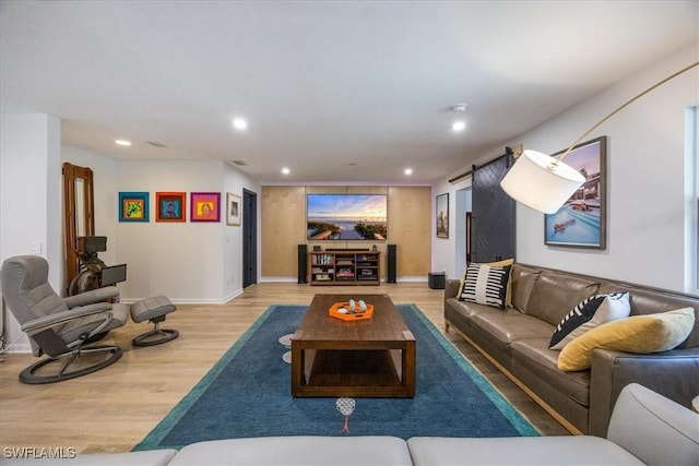 living room featuring wood finished floors, recessed lighting, and baseboards