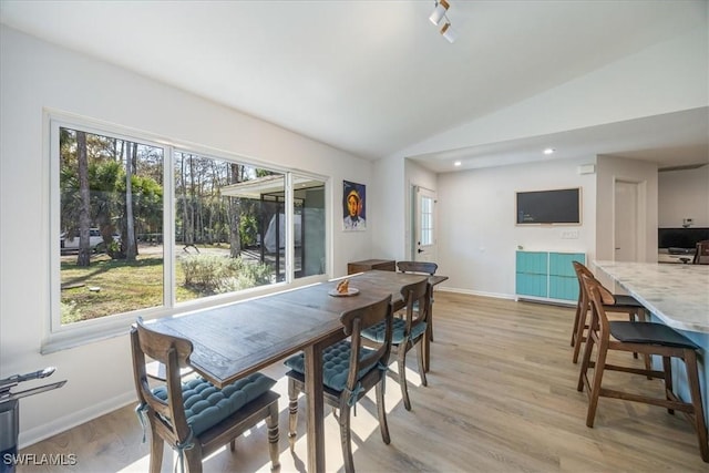 dining space with light wood-style flooring, recessed lighting, vaulted ceiling, and baseboards