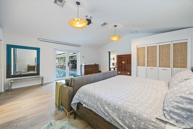 bedroom with visible vents, wood finished floors, access to exterior, and vaulted ceiling