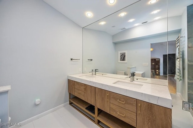 bathroom with double vanity, toilet, lofted ceiling, and a sink