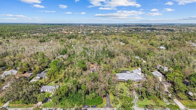 bird's eye view featuring a wooded view