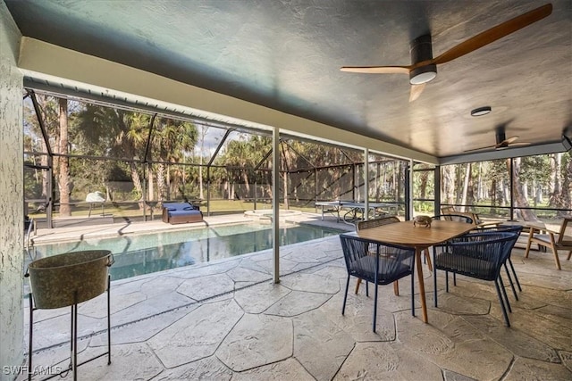 unfurnished sunroom with ceiling fan