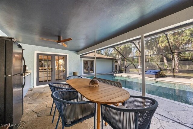 sunroom with a pool, french doors, and ceiling fan