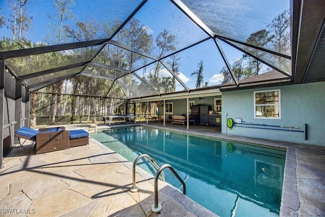 outdoor pool featuring outdoor lounge area, a patio, and glass enclosure