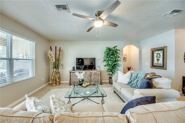 carpeted living room with ceiling fan