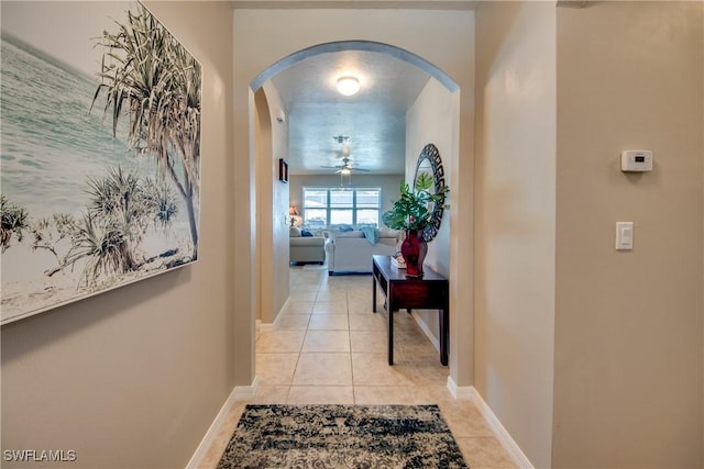 hall featuring light tile patterned floors