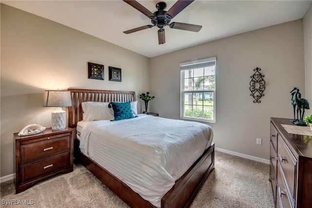 bedroom with ceiling fan and light carpet