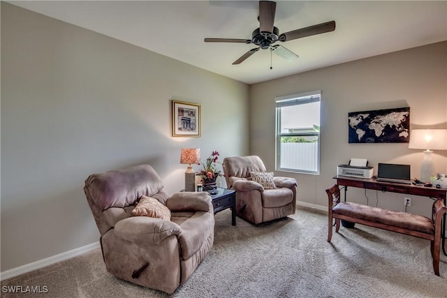 sitting room with ceiling fan and light carpet