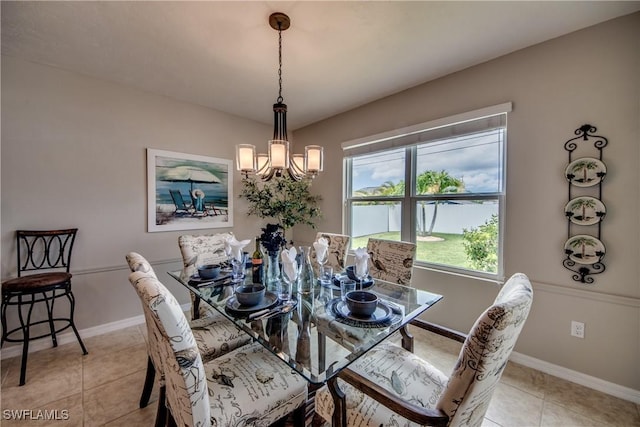 dining space featuring light tile patterned floors and an inviting chandelier