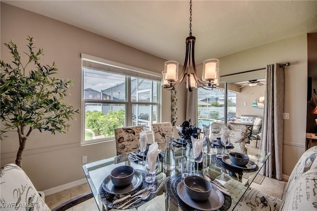 dining area with light tile patterned floors and a chandelier