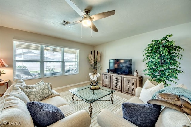 carpeted living room with ceiling fan