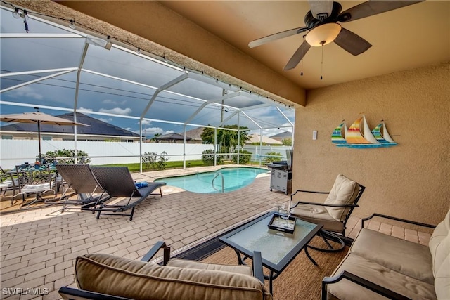 view of swimming pool with a lanai, a patio area, ceiling fan, and an outdoor hangout area