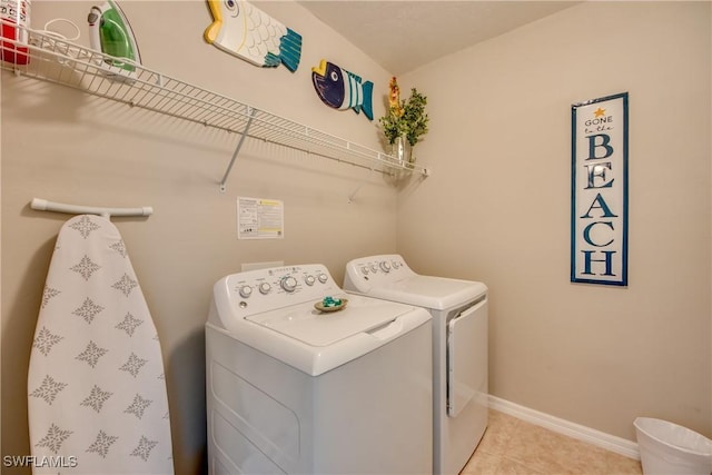 clothes washing area featuring separate washer and dryer and light tile patterned floors