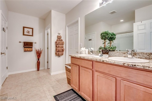 bathroom with tile patterned floors and vanity