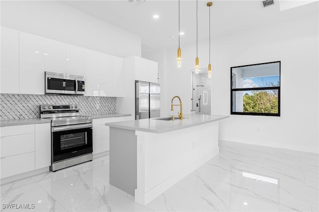 kitchen featuring white cabinets, stainless steel appliances, hanging light fixtures, and sink