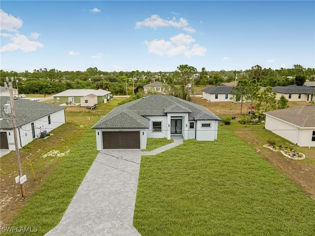 view of front of home featuring a front yard and a garage