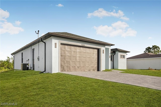 garage featuring cooling unit and a lawn