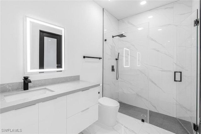 bathroom featuring vanity, toilet, and a shower with shower door