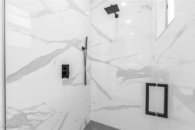 bathroom featuring a shower with shower door