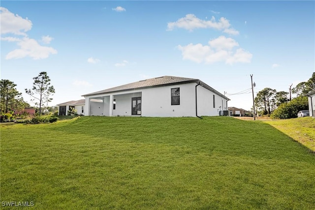 rear view of house featuring a yard