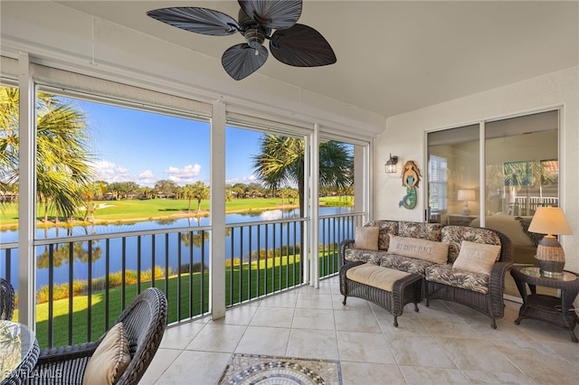 sunroom featuring a water view and ceiling fan