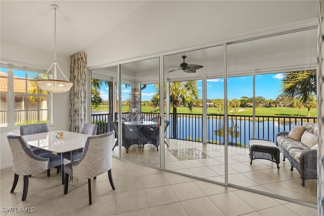 sunroom / solarium featuring ceiling fan, a water view, and lofted ceiling