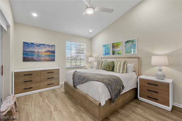 bedroom with light wood-type flooring, vaulted ceiling, and ceiling fan