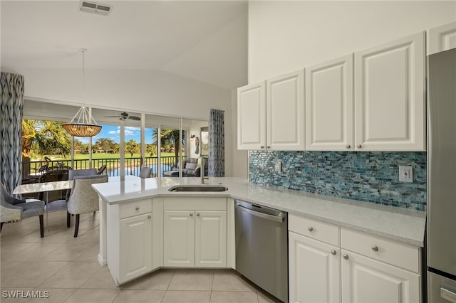 kitchen featuring kitchen peninsula, pendant lighting, lofted ceiling, white cabinets, and appliances with stainless steel finishes