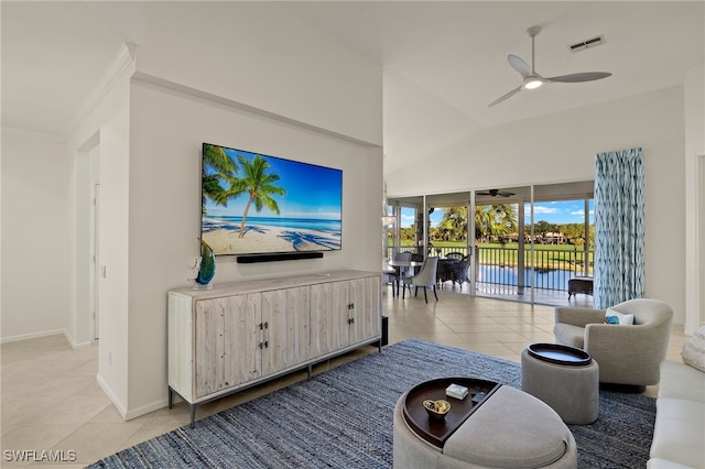 living room featuring ceiling fan, light tile patterned floors, and lofted ceiling