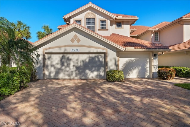 mediterranean / spanish-style home with a garage