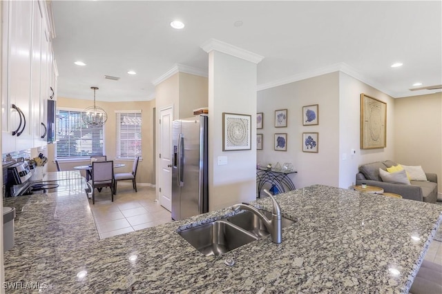 kitchen featuring pendant lighting, stone counters, white cabinets, sink, and stainless steel appliances