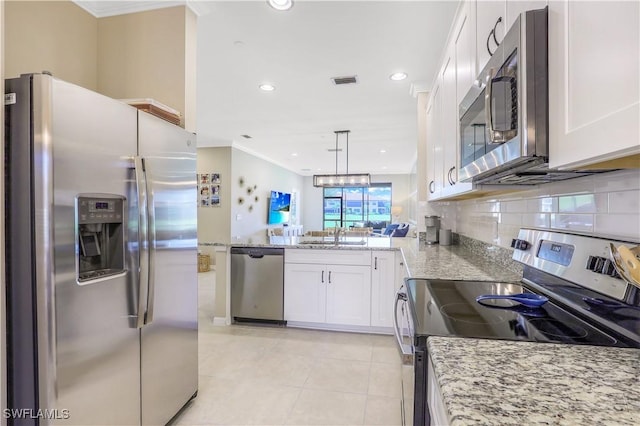 kitchen with kitchen peninsula, stainless steel appliances, pendant lighting, light tile patterned floors, and white cabinets