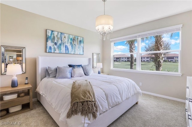 bedroom featuring light colored carpet and an inviting chandelier