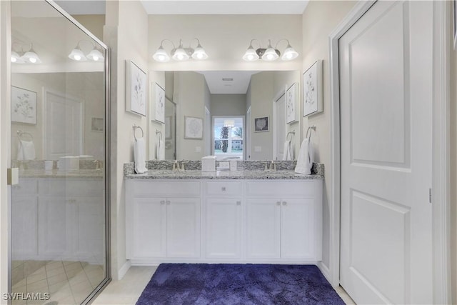 bathroom featuring vanity and an enclosed shower