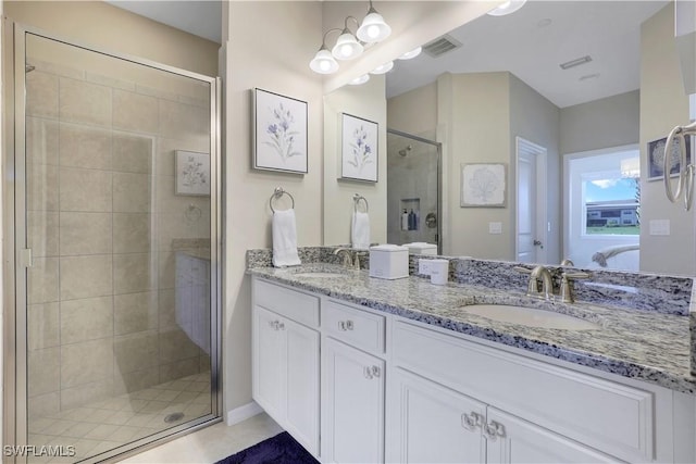 bathroom with tile patterned flooring, vanity, and a shower with shower door